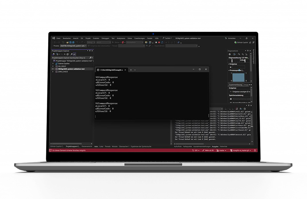 Laptop screen displaying ISOAgLib SE development environment with modular API and debugging interface. ISOAgLib SE accelerates ISOBUS projects with ISO 11783 and ISO 25119-SRL 2 compliance, AEF certification, and broad hardware compatibility.