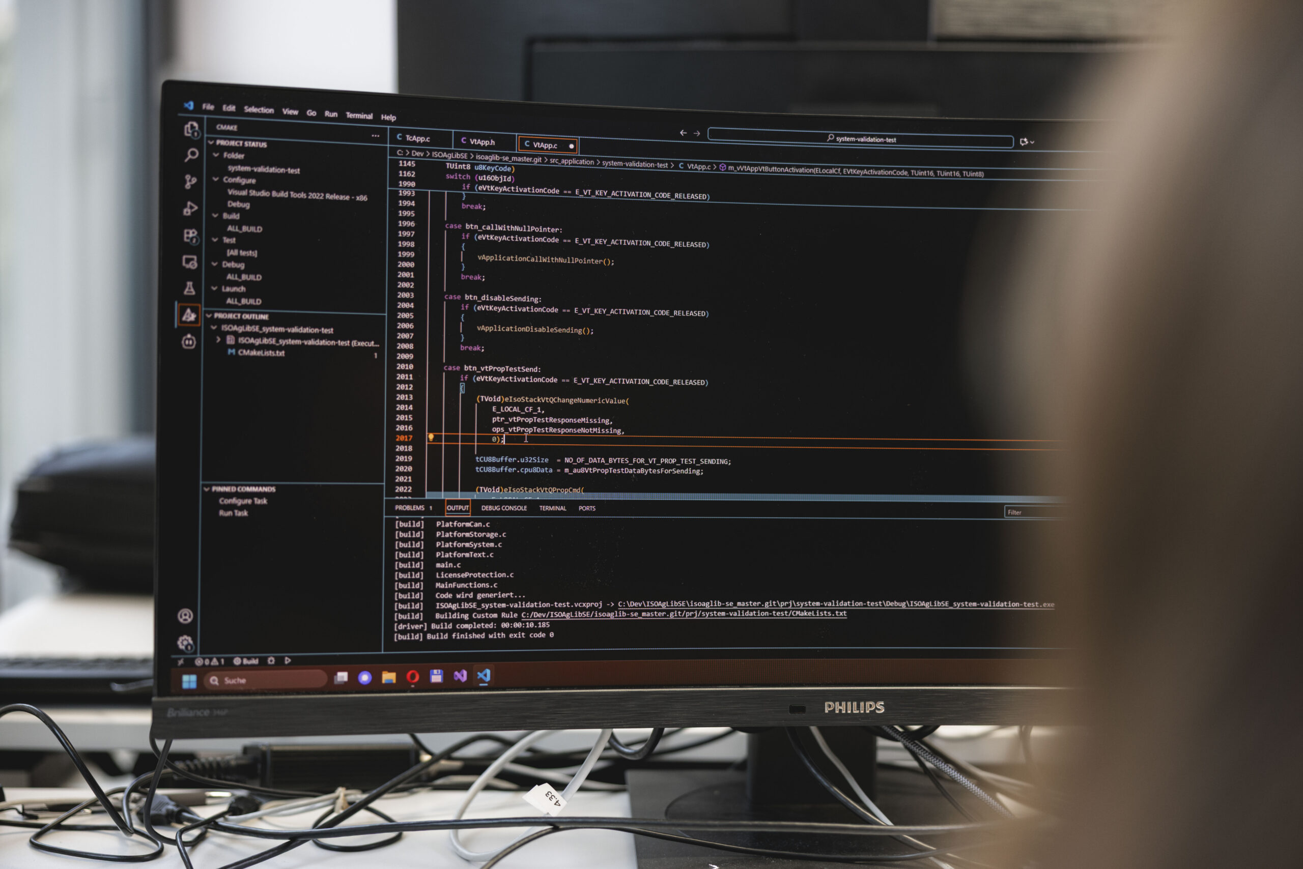Software developer programming ISOBUS control system for agricultural machinery at ISOdev